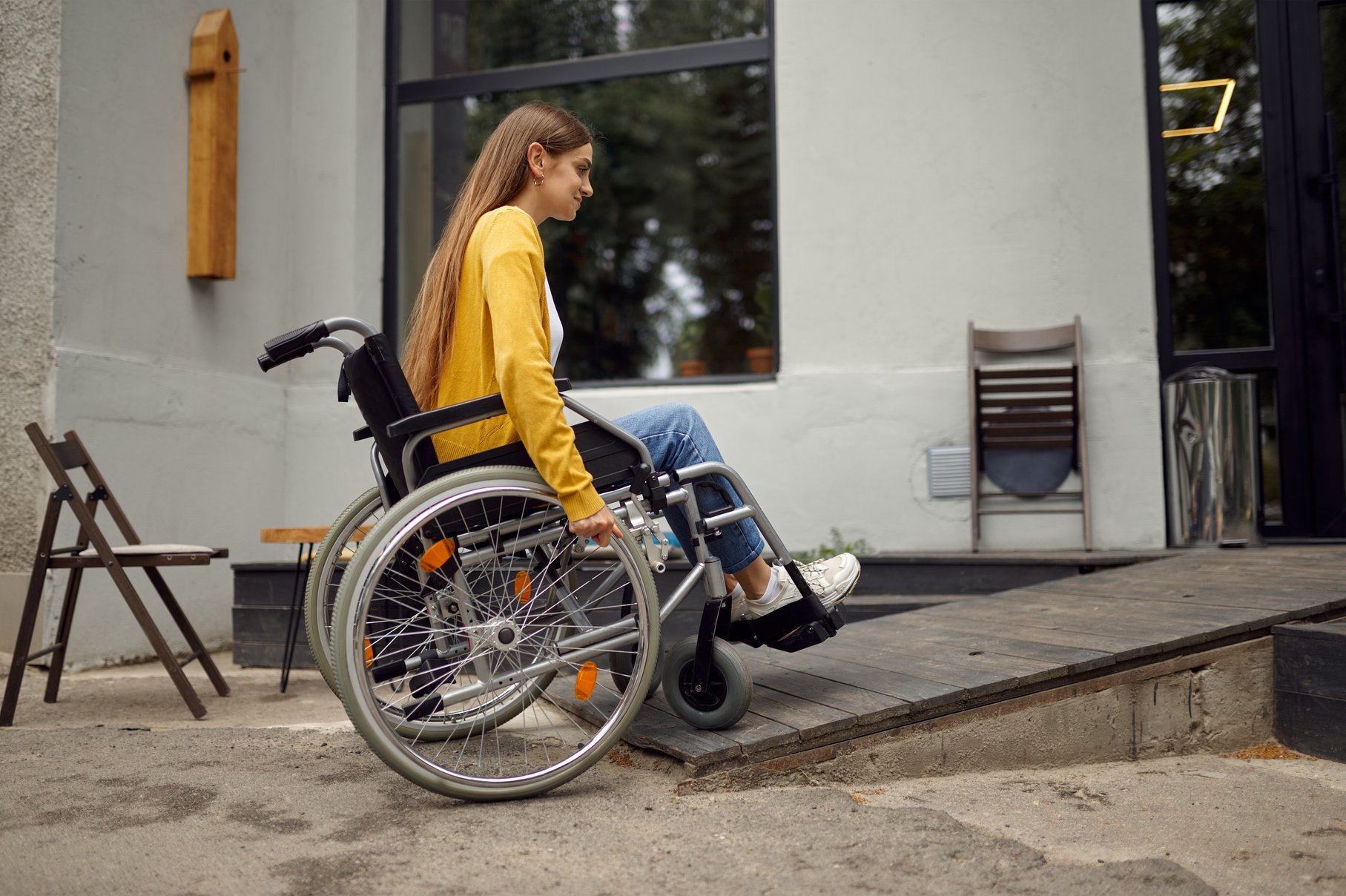 Disabled Student in Wheelchair at the Ramp in Cafe